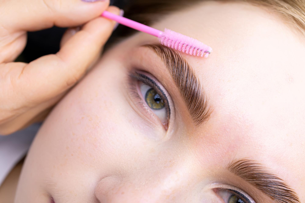 macro photography model s hairs master combs eyebrow hairs with pink brush after procedure long term styling lamination