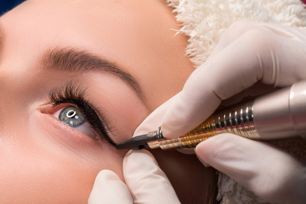 permanent eye makeup close up shot cosmetologist applying tattooing eyes